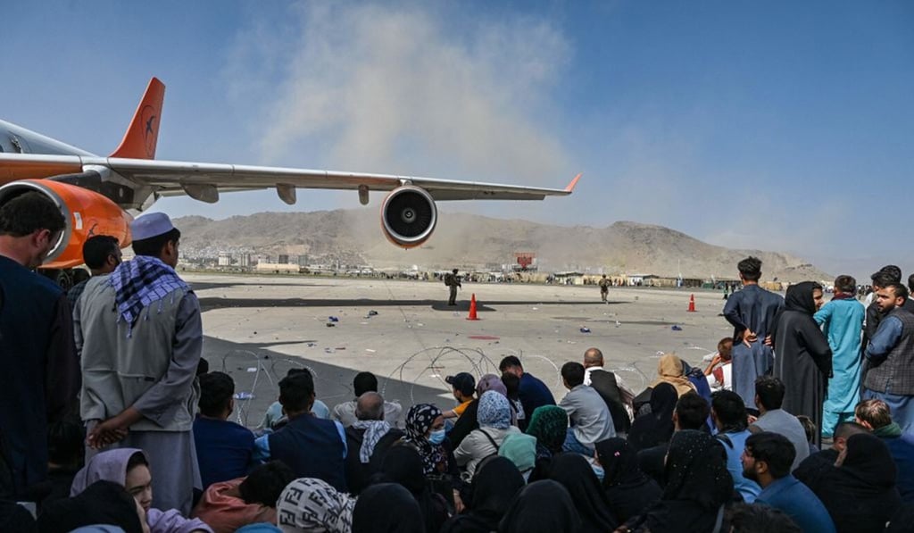 Afghan people waiting to board a plane at the Kabul airport on Monday. Thousands mobbed the airport trying to flee the Taliban's return. Photo: AFP via Getty Images/TNS Afghan people waiting to board a plane at the Kabul airport on Monday. Thousands mobbed the airport trying to flee the Taliban's return. Photo: AFP via Getty Images/TNS