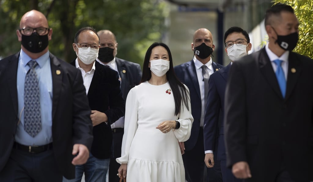 Meng Wanzhou, surrounded by security personnel, returns to court after a break in her extradition hearing in Vancouver, British Columbia, on Tuesday. Photo: AP