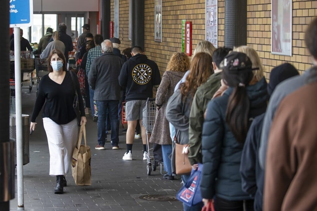 Shoppers queue up to enter a supermarket in Auckland on August 17, 2021, ahead of a nationwide lockdown. Photo: NZ Herald via AP