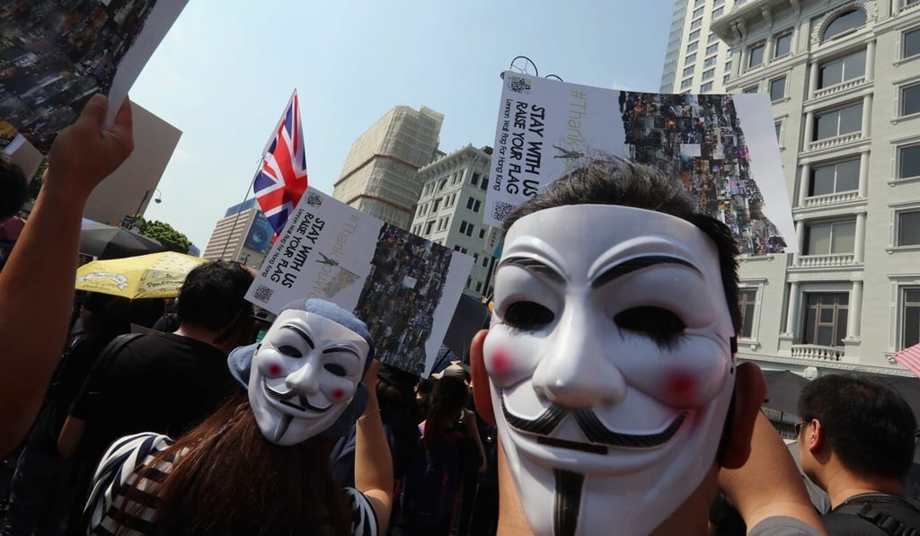 Anti-government protesters wearing Guy Fawkes masks walk along Salisbury Road in Tsim Sha Tsui during a march on October 20, 2019. Photo: Felix Wong