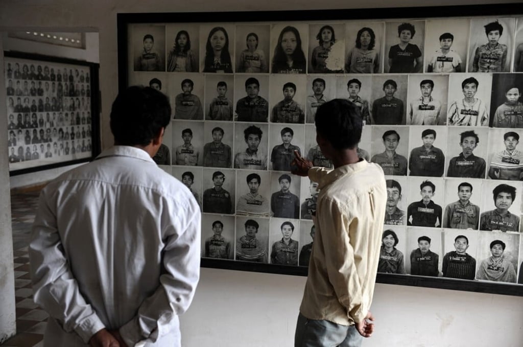 Visitors look at portraits of victims displayed at the Tuol Sleng prison, where thousands of Cambodians died during the Khmer Rouge regime. File photo: AFP