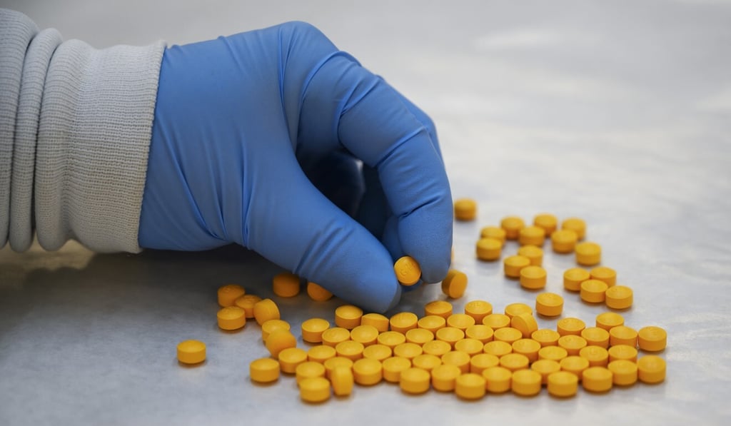 A Drug Enforcement Administration (DEA) chemist checking confiscated tablets containing fentanyl at the DEA Northeast Regional Laboratory in New York in 2019. Photo: AFP