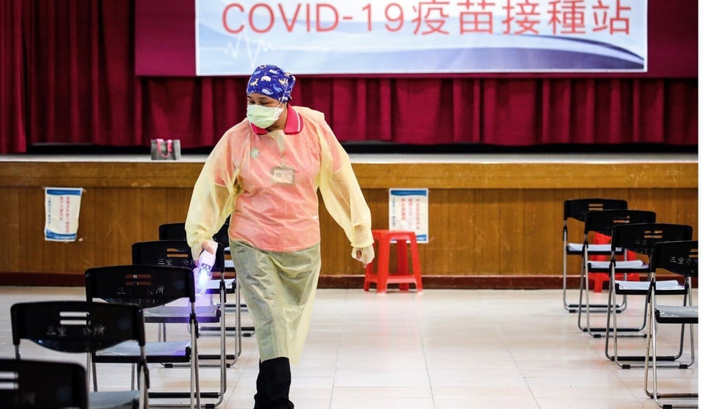 A health worker disinfects a vaccination centre in Taipei on Monday. Photo: Bloomberg