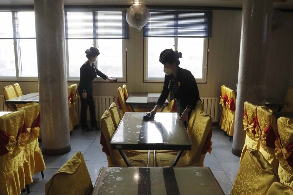 In this February 5, 2021 photo, staff of the Pongnam Noodle House disinfect the tables and windows of the restaurant in Pyongyang, North Korea. A UN rapporteurs’ letter has expressed concern about an alleged order in which any trespassers who cross its northern border in violation of the country’s pandemic closure would be shot on sight. Photo: AP