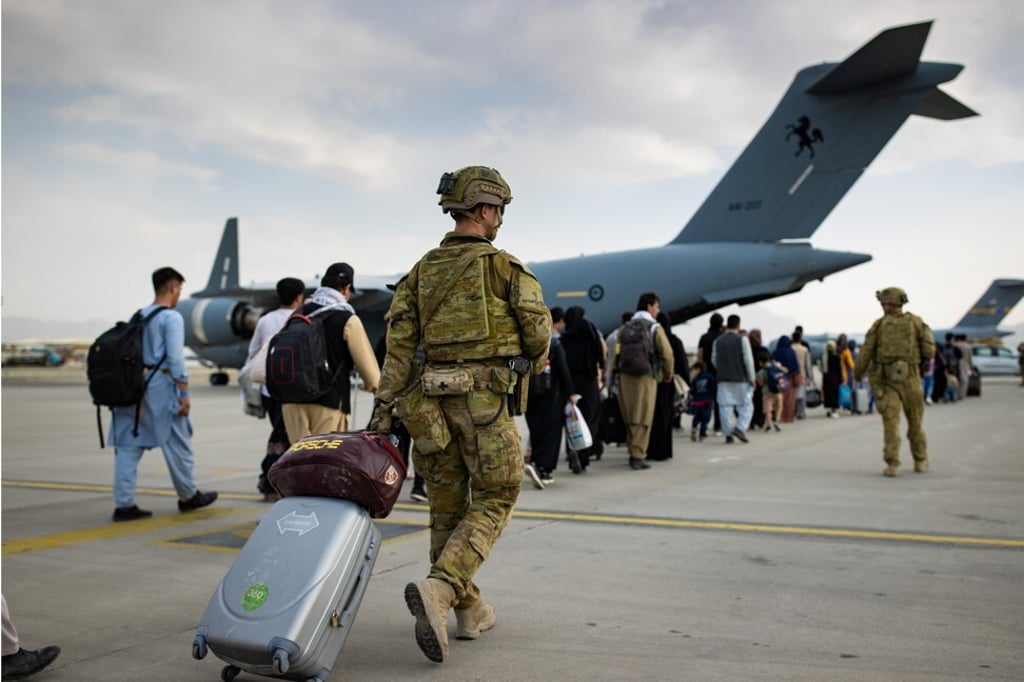 Australian citizens and visa holders prepare to board an aircraft in Kabul on August 22, 2021. Photo: Australia's Department of Defence/Reuters