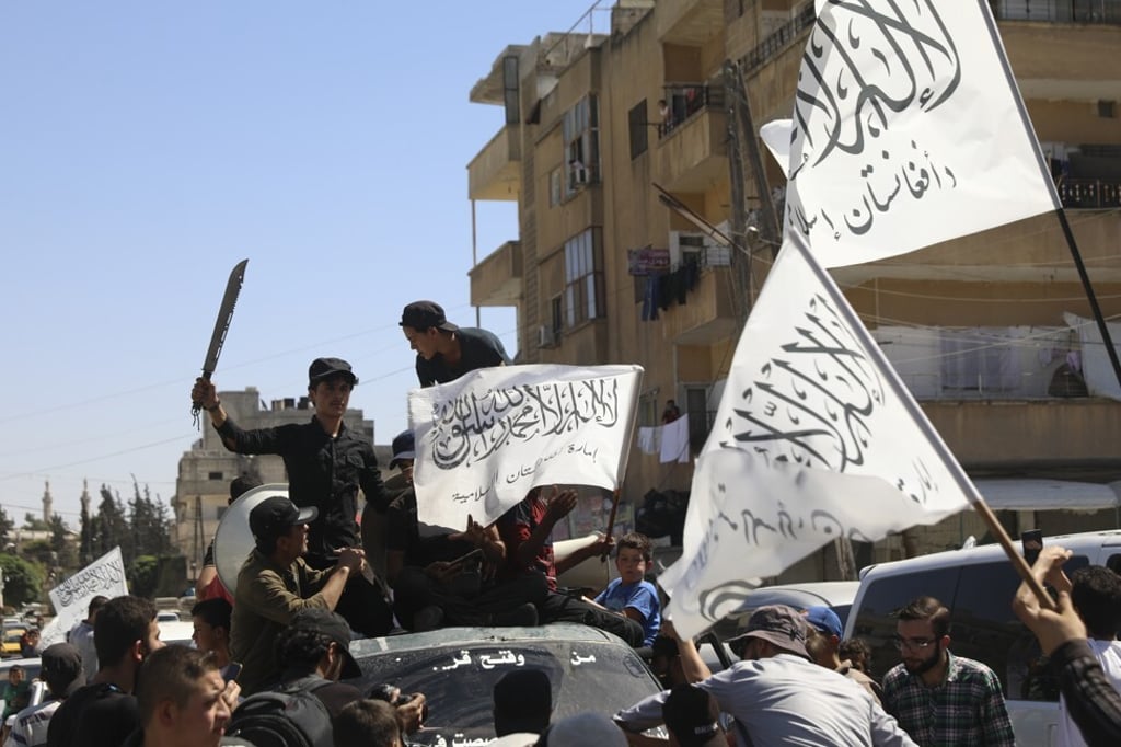 Members of the Hayat Tahrir al-Sham, a Sunni Islamist militant group, wave the Taliban flags as they celebrate the Taliban takeover of Afghanistan. Photo: AP