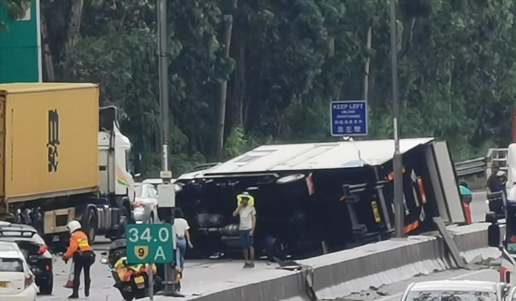 A 5½-tonne truck lies on its side on Hong Kong’s San Tin Highway after a collision with a Porsche sports car on Sunday. Photo: Handout A 5½-tonne truck lies on its side on Hong Kong’s San Tin Highway after a collision with a Porsche sports car on Sunday. Photo: Handout