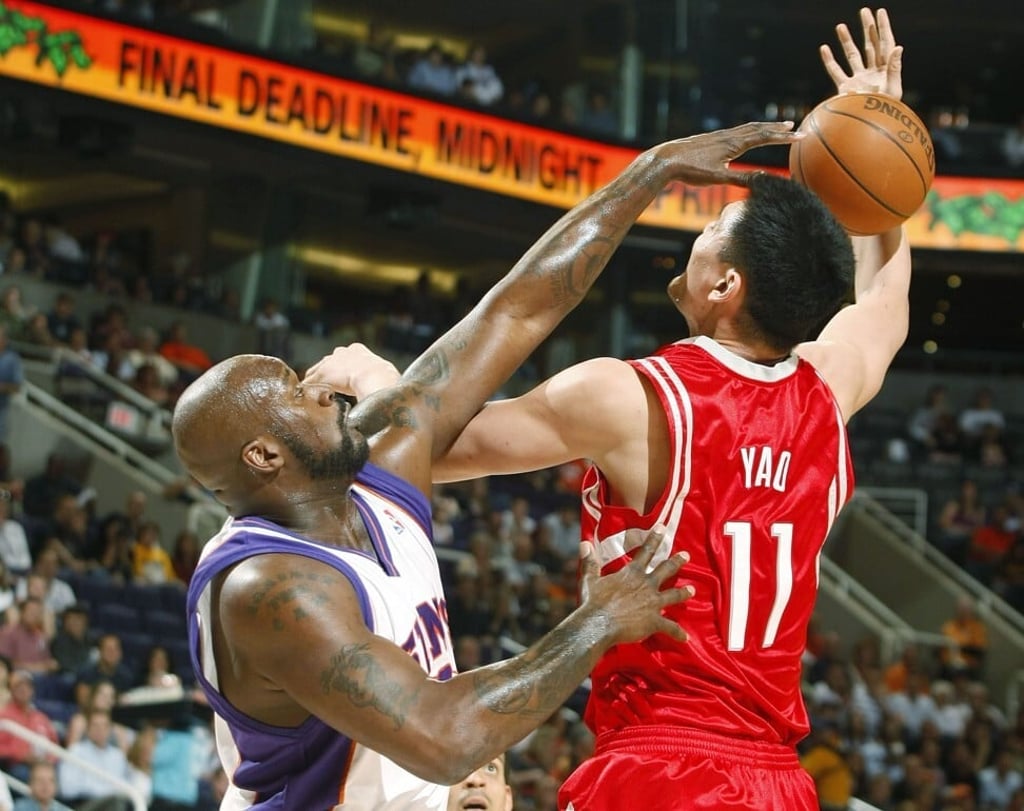 Phoenix Suns centre Shaquille O’Neal fouls Yao Ming in a 2009 NBA game. Photo: Reuters