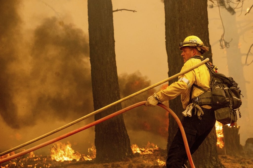 A firefighter battles the Caldor Fire near South Lake Tahoe, California on Tuesday. Photo: AP