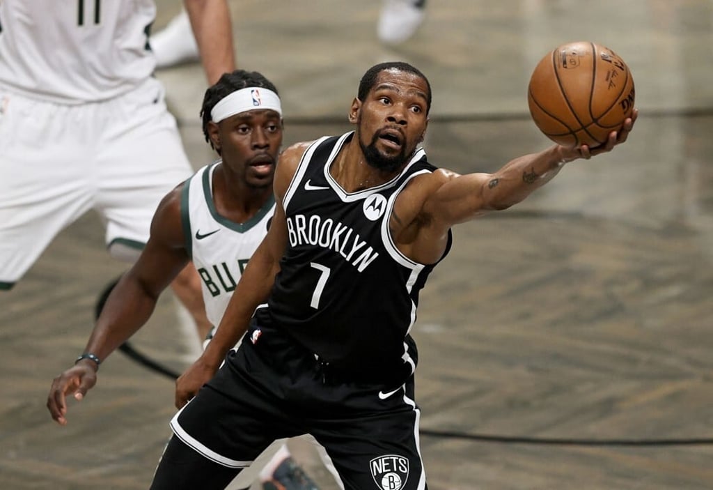 Kevin Durant of the Brooklyn Nets grabs the loose ball as Jrue Holiday of the Milwaukee Bucks defends in the first half during game seven of their Eastern Conference second round tie on June 23, 2021. Photo: AFP Kevin Durant of the Brooklyn Nets grabs the loose ball as Jrue Holiday of the Milwaukee Bucks defends in the first half during game seven of their Eastern Conference second round tie on June 23, 2021. Photo: AFP