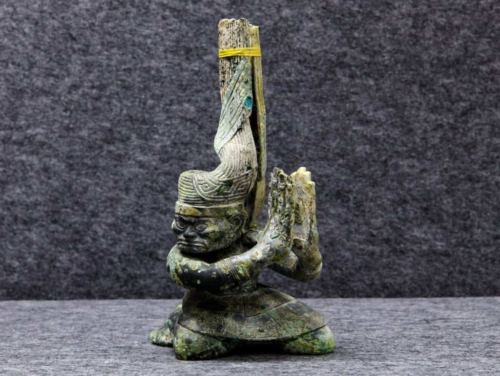 A head-turned kneeling bronze figure was discovered at the Sanxingdui ruins over the summer. Photo: Xinhua A head-turned kneeling bronze figure was discovered at the Sanxingdui ruins over the summer. Photo: Xinhua