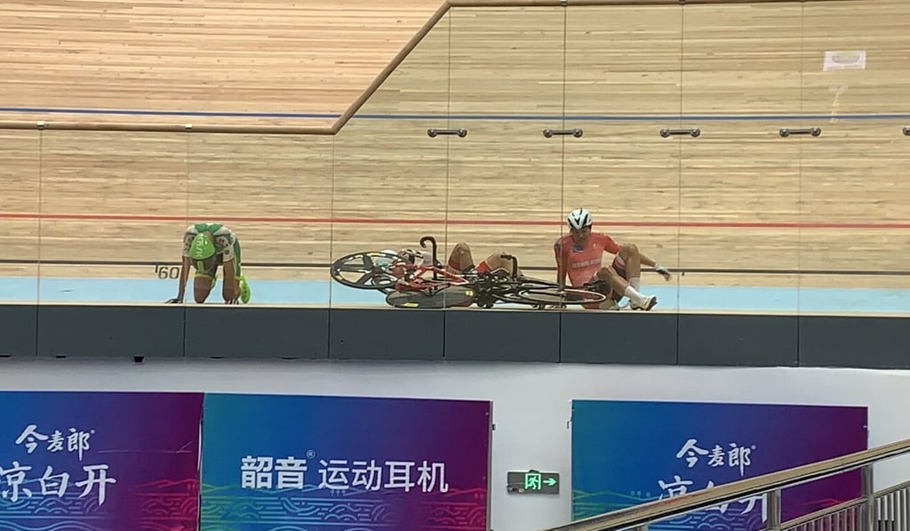 Leung Ka-yu (in red) crashes with seven laps in remaining in the points race of the omnium. Photo: Cycling Association