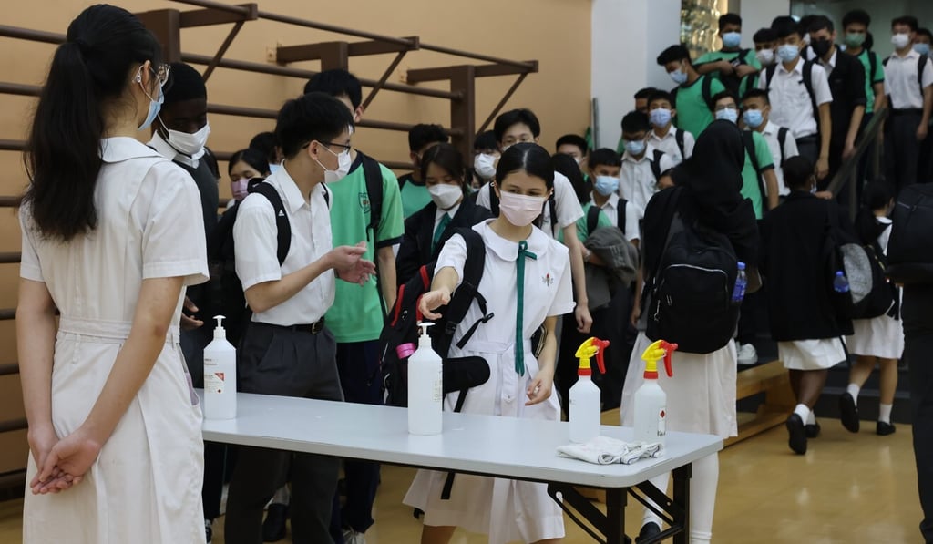 Students are required to sanitise their hands as they enter Delia Memorial School (Hip Wo) in Kwun Tong. Photo: Nora Tam Students are required to sanitise their hands as they enter Delia Memorial School (Hip Wo) in Kwun Tong. Photo: Nora Tam