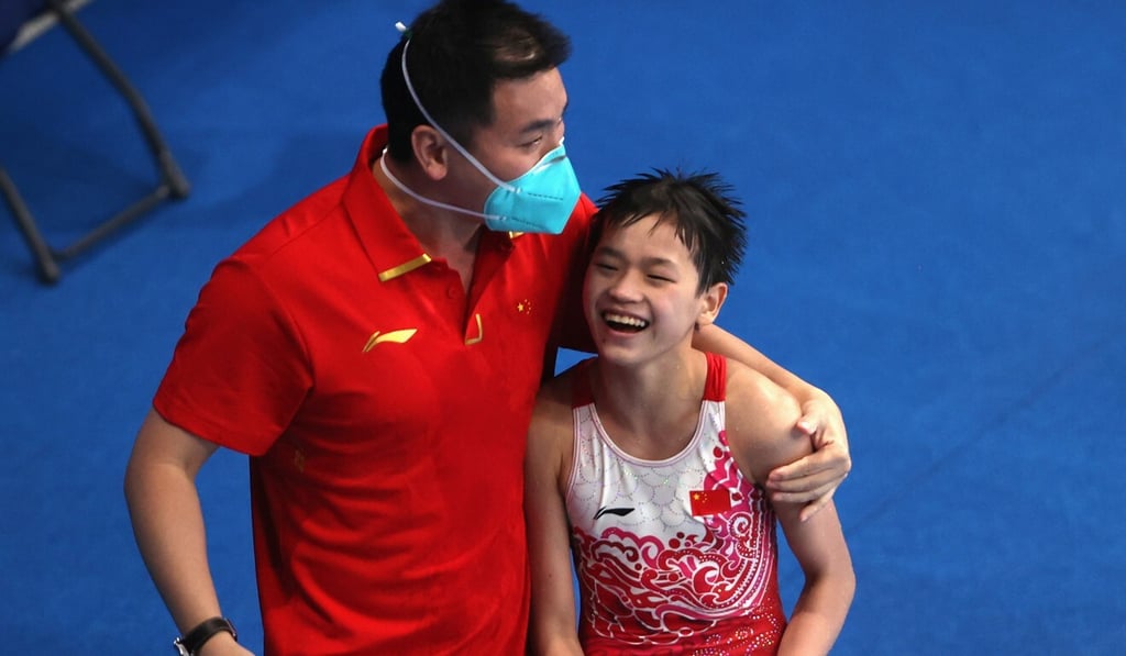 Quan Hongchan of China reacts with her coach after a dive at the Tokyo 2020 Olympics. Photo: Reuters Quan Hongchan of China reacts with her coach after a dive at the Tokyo 2020 Olympics. Photo: Reuters