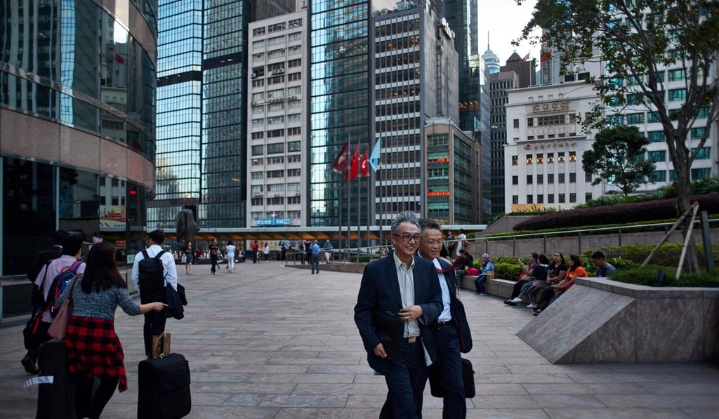 A photo from October 2017 shows pedestrians walking outside the Three Exchange Square building (left), which houses the Hong Kong stock exchange. Photo: AFP