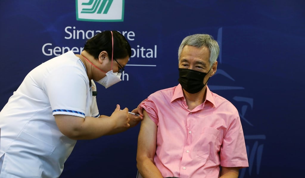 Singapore Prime Minister Lee Hsien Loong receives a Covid-19 vaccine booster shot on Friday. Photo: MCI via Reuters Singapore Prime Minister Lee Hsien Loong receives a Covid-19 vaccine booster shot on Friday. Photo: MCI via Reuters