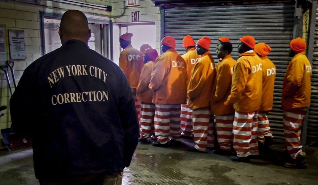 A corrections official watches inmates file out of a prison bakery after working the morning shift at the Rikers Island jail in New York. Photo: AP