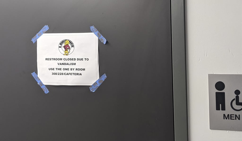 A sign is seen on a closed restroom at Lawrence High School in Kansas on Friday. Photo: Cuyler Dunn via AP