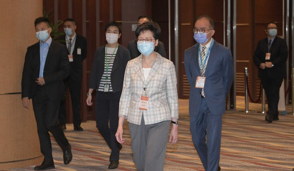Chief Executive Carrie Lam arrives at the Wan Chai polling station on Sunday morning. Photo: Felix Wong
