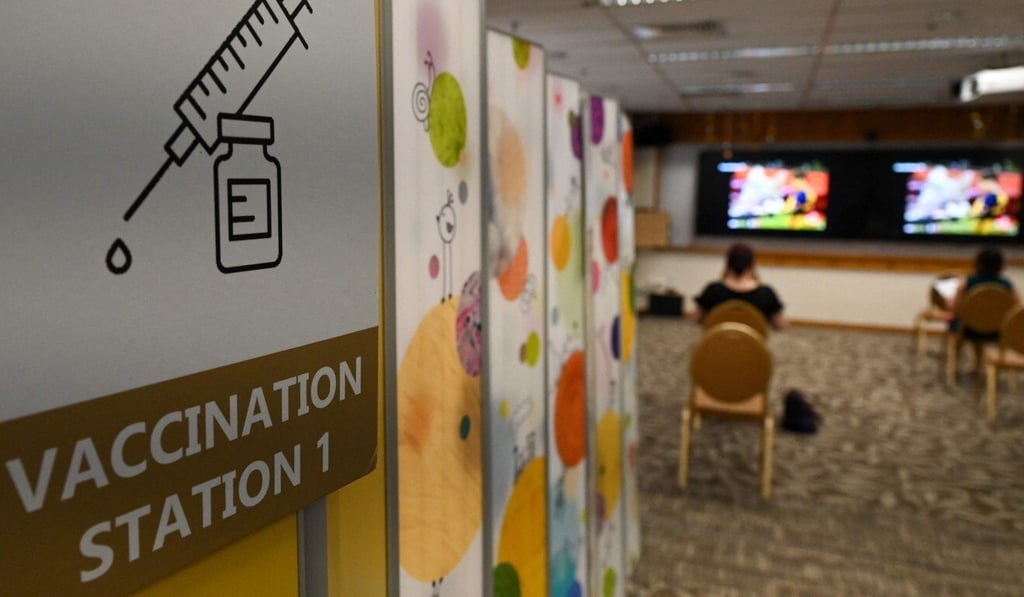 People sit and wait after receiving a dose of Covid-19 vaccine at a hospital in Singapore this month. Photo: AFP