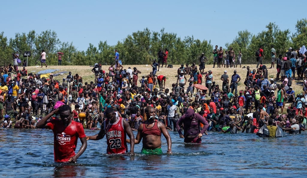 Haitian migrants, part of a group of over 10,000 people staying in an encampment on the US side of the border, cross the Rio Grande river to get food and water in Mexico on Sunday. Photo: AFP