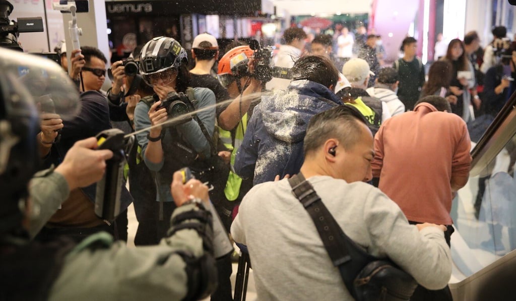 Police fire pepper spray while trying to detain a man inside Landmark North shopping centre. Photo: Winson Wong Police fire pepper spray while trying to detain a man inside Landmark North shopping centre. Photo: Winson Wong