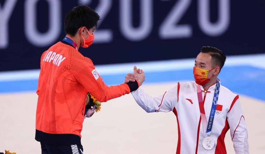 Tokyo 2020 Olympic Games men’s individual all-around gold medallist Daiki Hashimoto of Japan (left) with silver medallist Xiao Ruoteng of China at the Ariake Gymnastics Centre in Tokyo, Japan. Photo: Reuters Tokyo 2020 Olympic Games men’s individual all-around gold medallist Daiki Hashimoto of Japan (left) with silver medallist Xiao Ruoteng of China at the Ariake Gymnastics Centre in Tokyo, Japan. Photo: Reuters