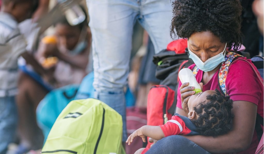 A migrant mother feeds her child in Del Rio, Texas. Photo: Getty Images/AFP A migrant mother feeds her child in Del Rio, Texas. Photo: Getty Images/AFP