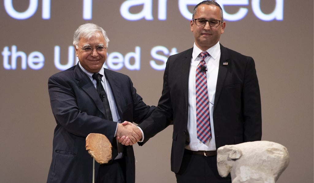 Iraq’s Ambassador to the US Fareed Yasseen (left) shakes hands with US Homeland Security official Steven Francis in front of the Gilgamesh tablet and Sumerian ram at a repatriation ceremony at the Smithsonian Institution National Museum of the American Indian on Thursday. Photo: EPA-EFE