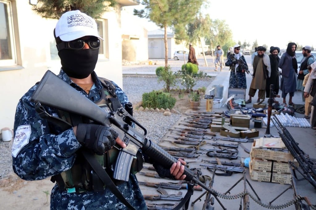 Taliban fighters display weapons and ammunition seized during an operation in Kandahar, Afghanistan on Saturday. Photo: EPA-EFE