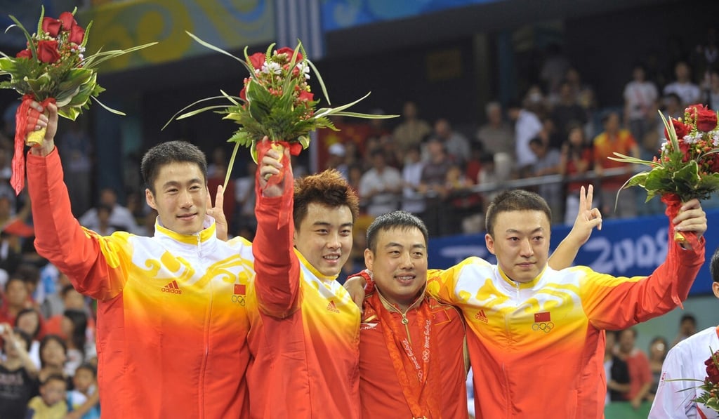 China’s team members (from left) Wang Liqin, Wang Hao, coach Liu Guoliang and Ma Lin pose on the podium for the men’s team table tennis final for the Beijing Olympic Games, at the Peking University Gymnasium on August 18, 2008. China defeated Germany 0-3. Photo: AFP China’s team members (from left) Wang Liqin, Wang Hao, coach Liu Guoliang and Ma Lin pose on the podium for the men’s team table tennis final for the Beijing Olympic Games, at the Peking University Gymnasium on August 18, 2008. China defeated Germany 0-3. Photo: AFP