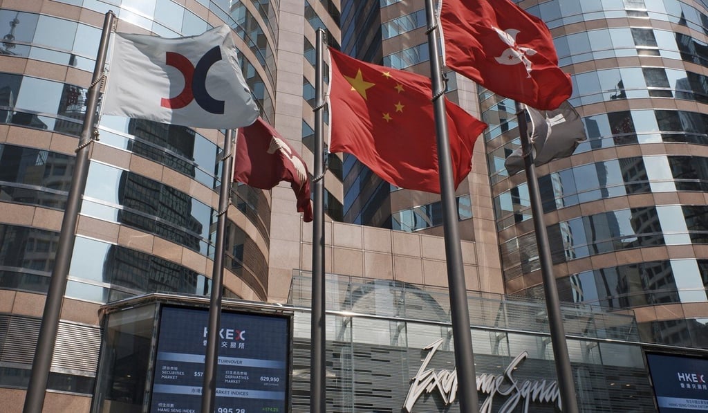 Flags are raised outside Exchange Square, which houses the Hong Kong stock exchange. HKEX, the bourse operator, says digital currency platforms can accelerate foreign exchange payments. Photo: AP Photo
