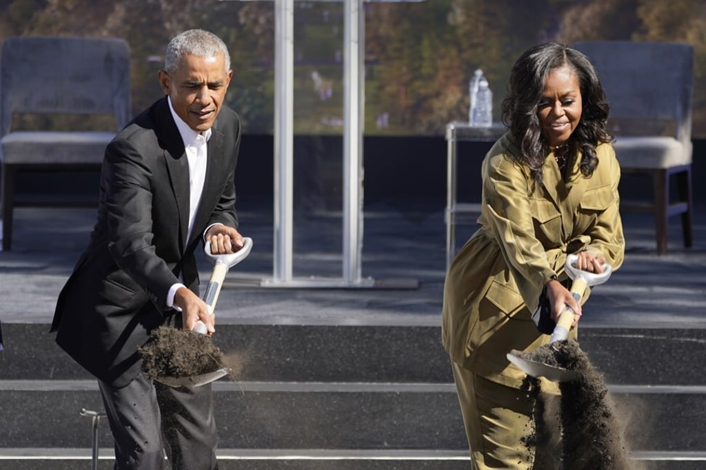 Former US President Barack Obama, left, and Michelle Obama toss dirt during a groundbreaking ceremony for the Obama Presidential Centre in Chicago on Tuesday. Photo: AP Former US President Barack Obama, left, and Michelle Obama toss dirt during a groundbreaking ceremony for the Obama Presidential Centre in Chicago on Tuesday. Photo: AP