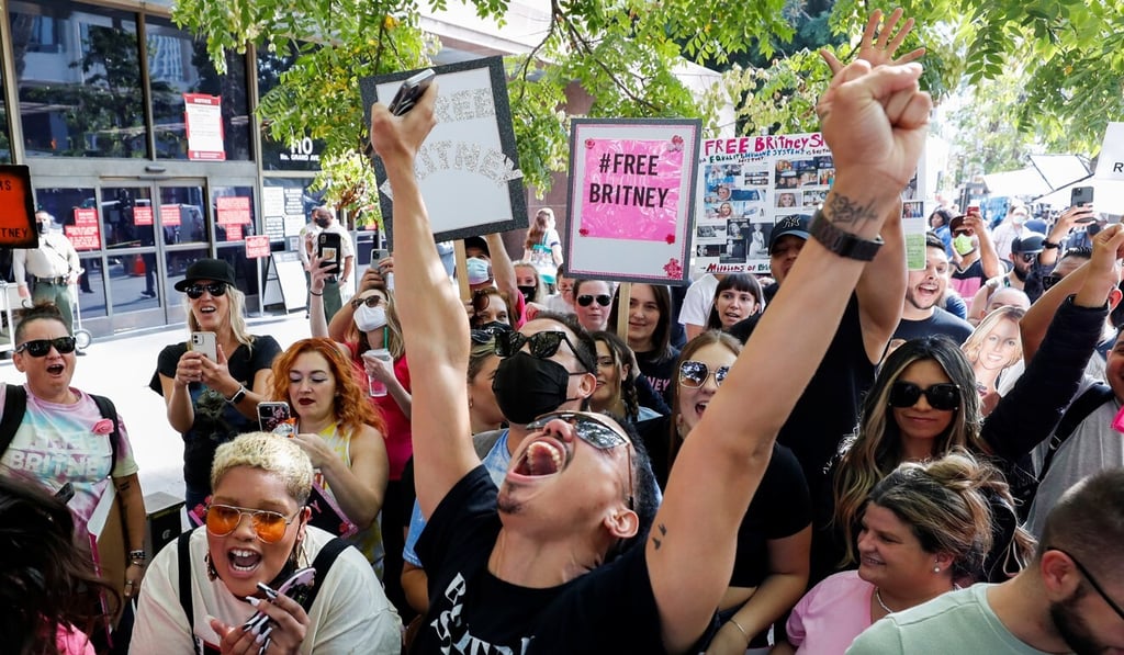 Supporters of pop star Britney Spears celebrate after a judge suspended her father from his 13-years-long role as the controller of the singer's business affairs at Stanley Mosk Courthouse in Los Angeles on Wednesday. Photo: Reuters