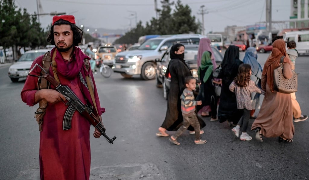 A member of Taliban stands guard along a road in Kabul. Photo: AFP