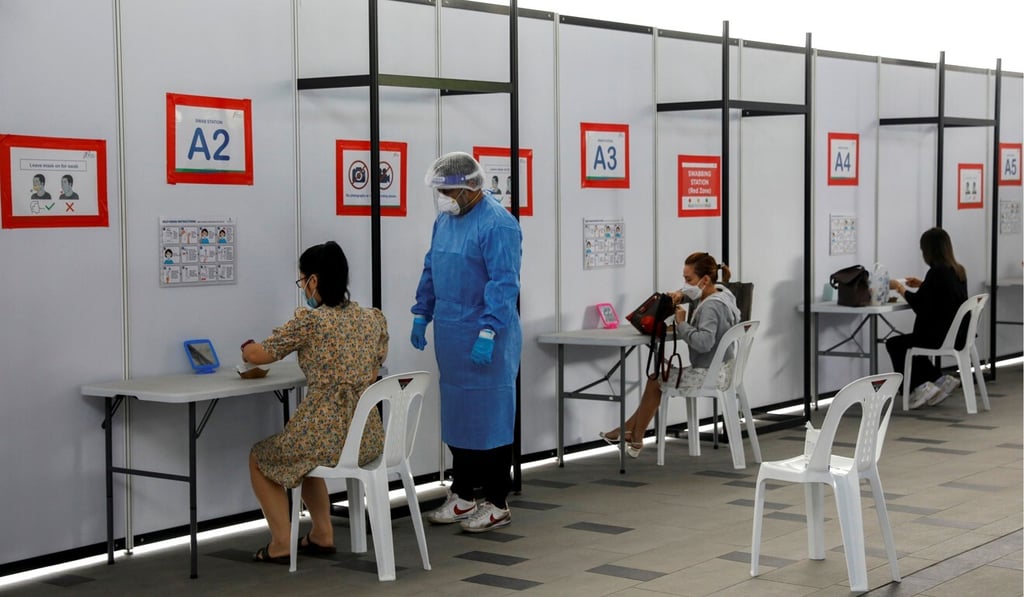 People take their antigen rapid test at a Centre in Singapore. Photo: Reuters