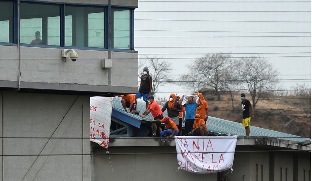Inmates hold banners reading
