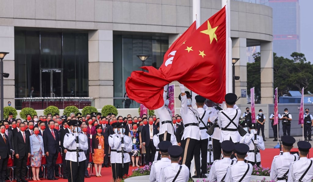 Police officers raise Chinese and Hong Kong flags during a ceremony to mark National Day at Golden Bauhinia Square in Wan Chai. Photo: Dickson Lee Police officers raise Chinese and Hong Kong flags during a ceremony to mark National Day at Golden Bauhinia Square in Wan Chai. Photo: Dickson Lee