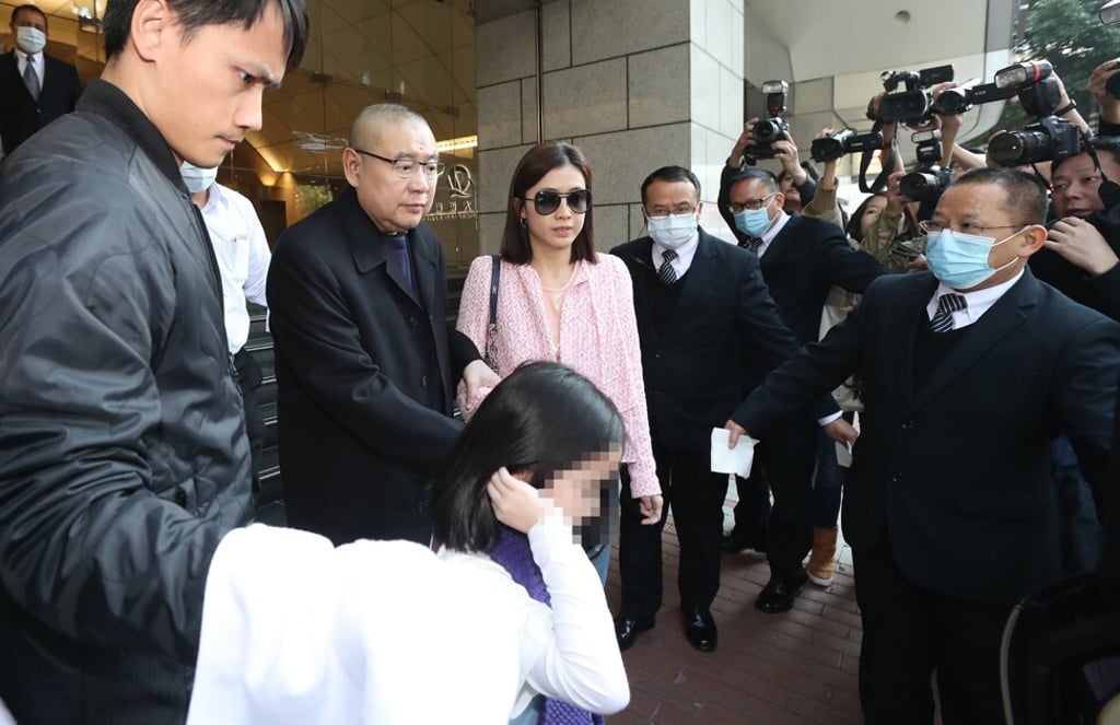 Joseph Lau (second Left) and his wife Chan Hoi-wan leave China Evergrande Centre in Wan Chai, Hong Kong, in a March 2017 file picture. Photo: Edward Wong