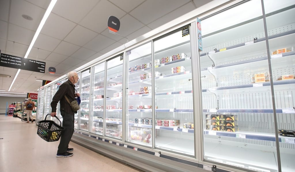 A shopper looks at produce and empty shelves of the meat aisle in co-op supermarket, Harpenden, Britain, September 22, 2021. Photo: Reuters