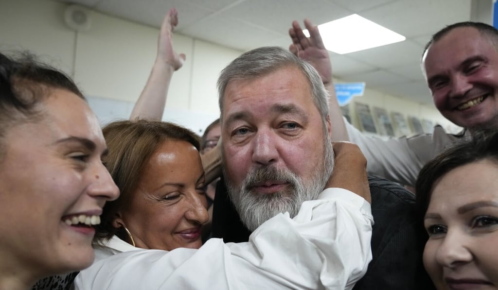 Colleagues congratulate editor Dmitry Muratov (centre) at the Novaya Gazeta newspaper in Moscow, Russia on Friday. Photo: AP Colleagues congratulate editor Dmitry Muratov (centre) at the Novaya Gazeta newspaper in Moscow, Russia on Friday. Photo: AP