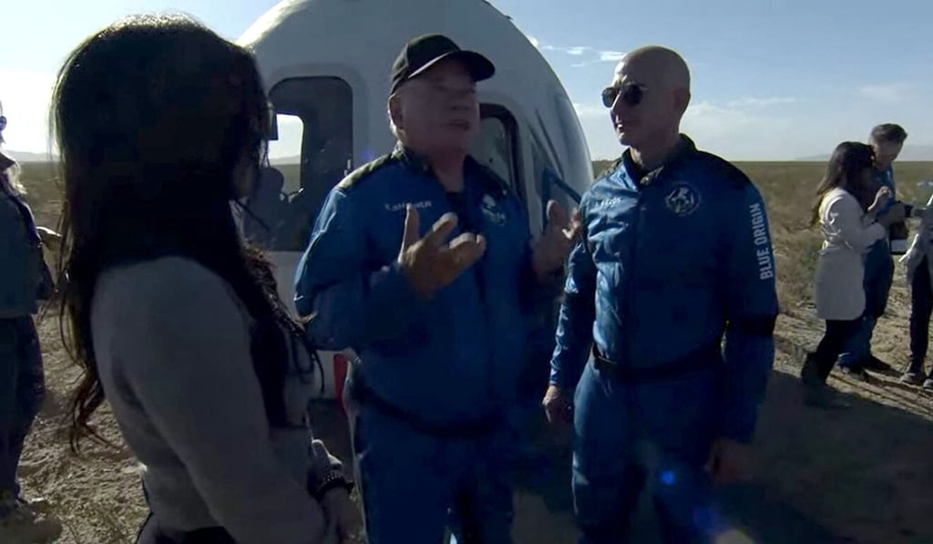 William Shatner (centre) speaks with Blue Origin founder Jeff Bezos on Wednesday after landing in the West Texas region. Photo: Blue Origin via AFP William Shatner (centre) speaks with Blue Origin founder Jeff Bezos on Wednesday after landing in the West Texas region. Photo: Blue Origin via AFP