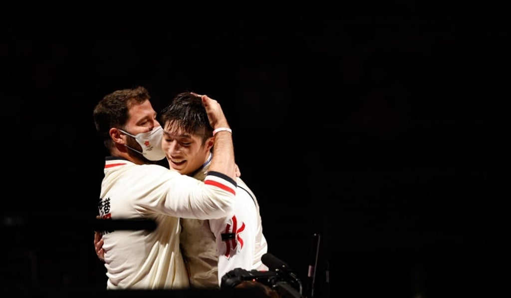 Coach Greg Koenig hugs Edgar Cheung Ka-long after the fencer won the Olympic gold medal at the Tokyo 2020 Olympic Games. Photo: Hong Kong Olympic Committee