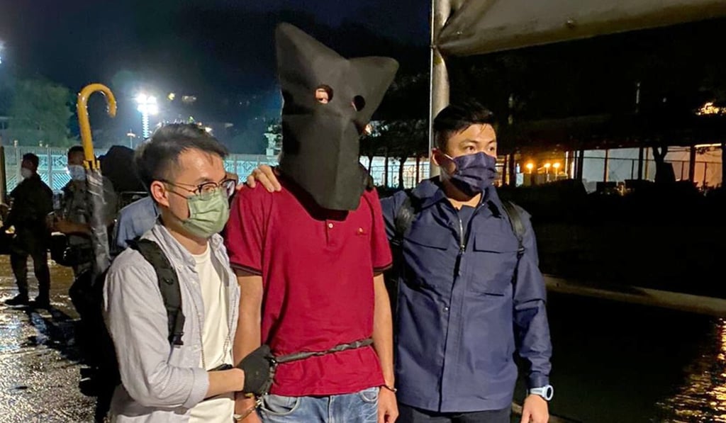 Police officers with the suspect in custody. Photo: SCMP