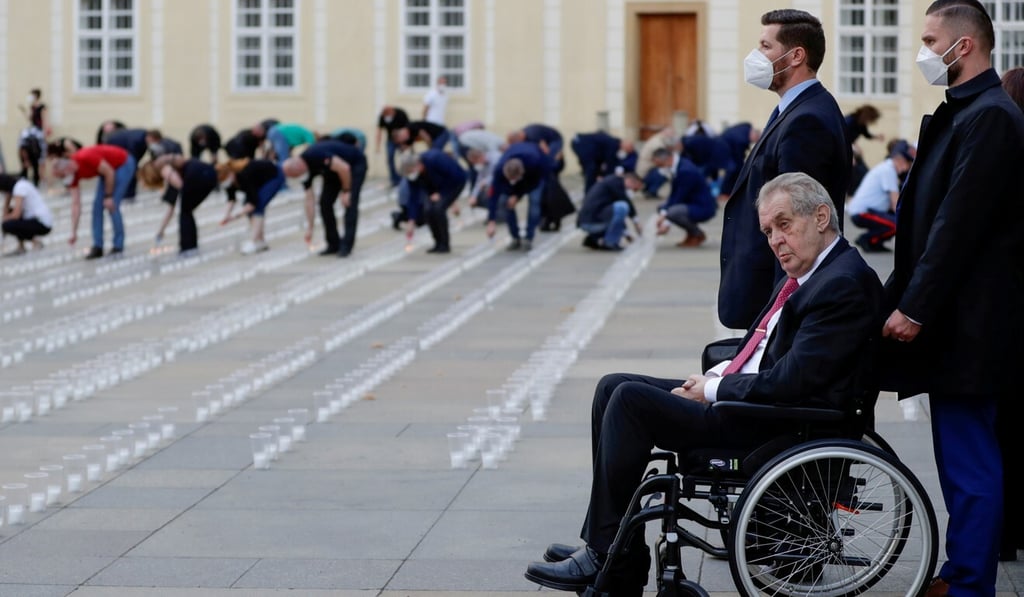 Czech President Milos Zeman watches as employees of Prague Castle light candles to commemorate the victims of the Covid-19 pandemic in May. Photo: Reuters
