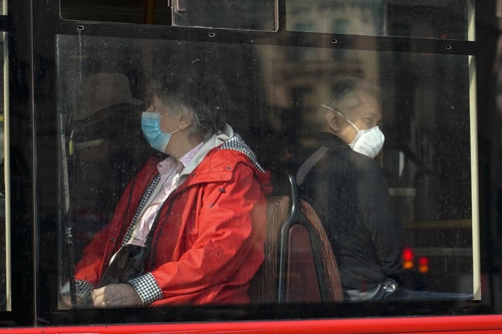 Passengers wear face masks on a bus in London. Photo: AP Passengers wear face masks on a bus in London. Photo: AP