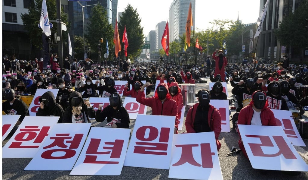 Members of the South Korean Confederation of Trade Unions wearing masks and costumes inspired by the Netflix series protest in Seoul. Photo: AP
