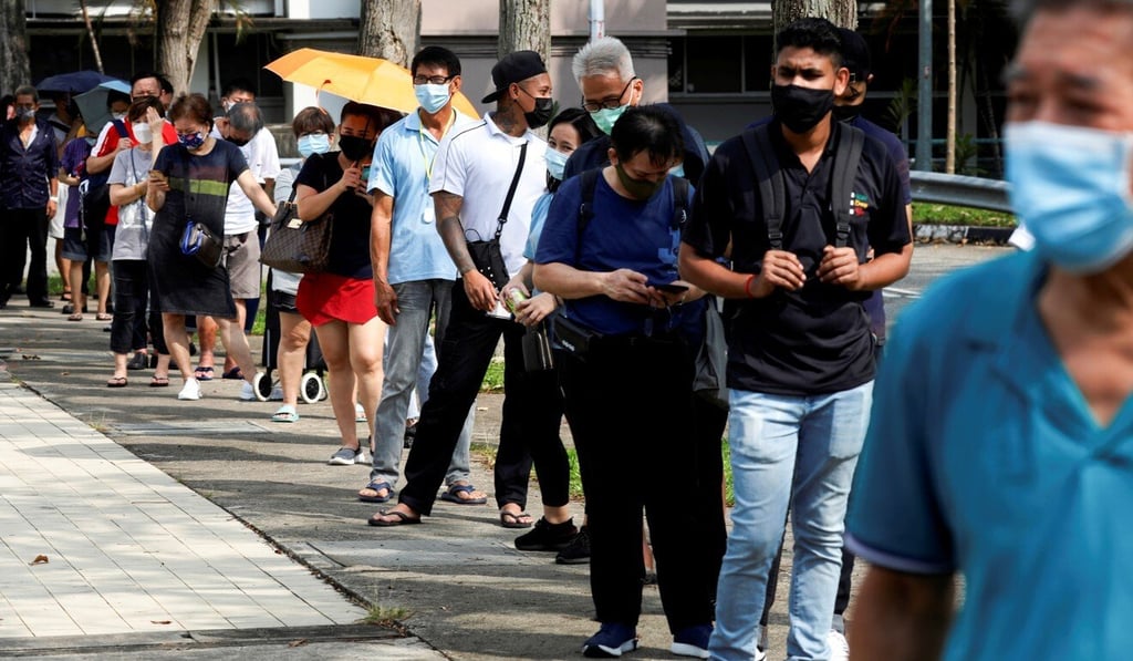 People queue to take Covid-19 antigen rapid tests in Singapore last month. Photo: Reuters