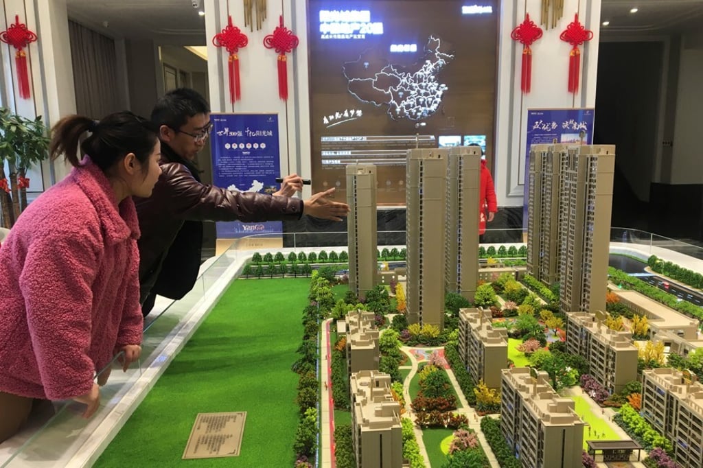 People look at a scale model of apartment buildings in a showroom of the property developer Yango in Xuchang city in Henan province on February 19, 2019. Photo: Reuters. People look at a scale model of apartment buildings in a showroom of the property developer Yango in Xuchang city in Henan province on February 19, 2019. Photo: Reuters.