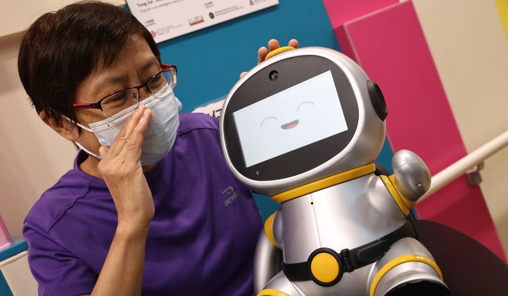 Retiree Chu Sau-lin interacts with Tung Zai at the elderly centre. Photo: K. Y. Cheng